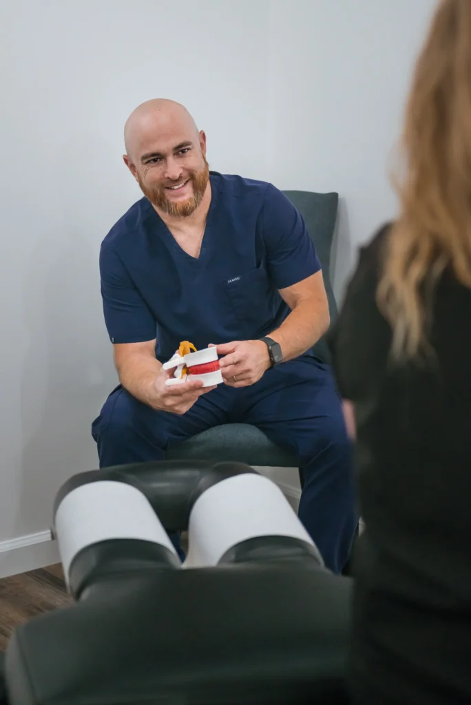 Chiropractor Dr. Dustin Nagai Helping a patient